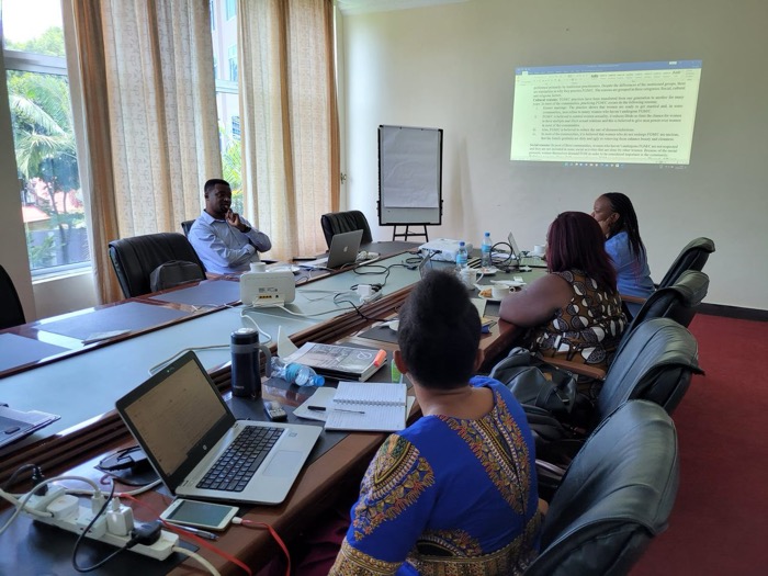 A professional training session in a boardroom with a presentation on screen