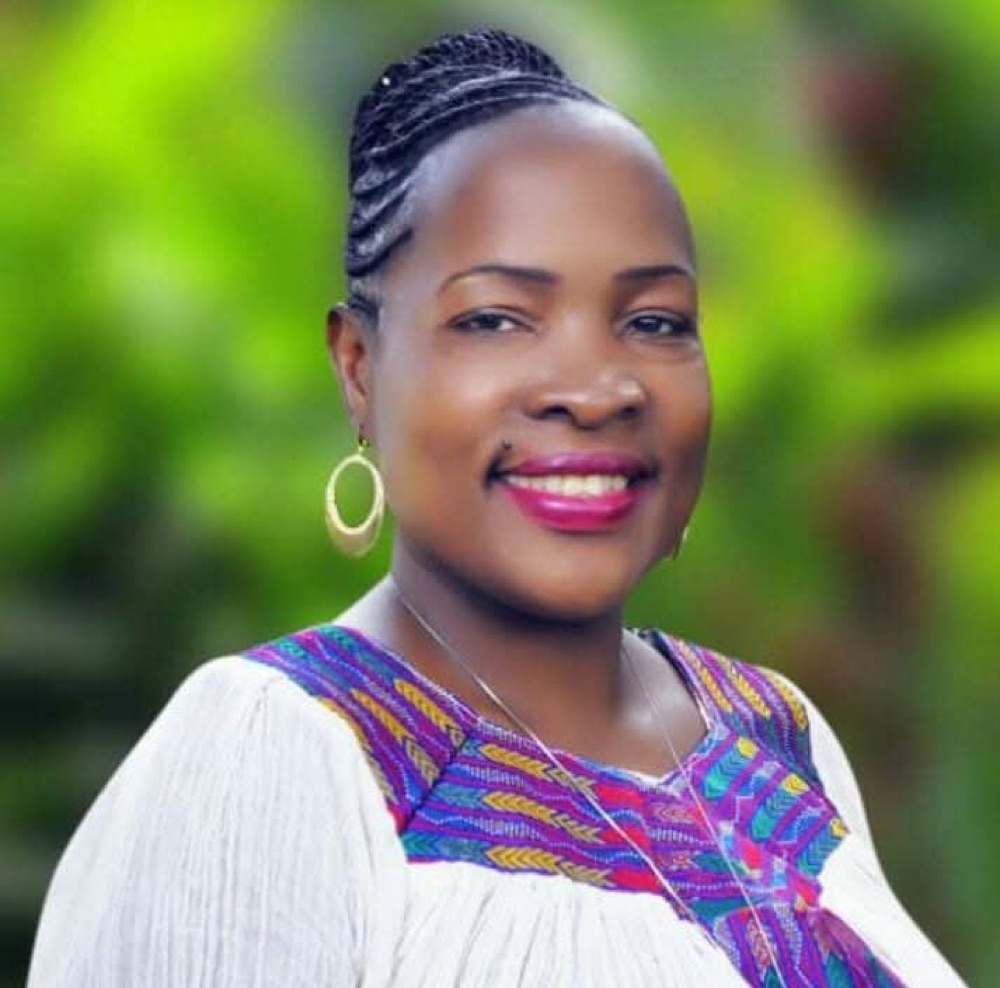 Rose Nyakato Kiiza smiling outdoors, founder of Thriving in Safe Places
